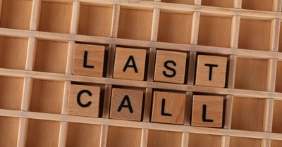 Wooden letter tiles forming the phrase 'Last Call' on a wooden background.