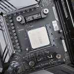 Detailed view of a gaming motherboard, showcasing an AMD processor and components.