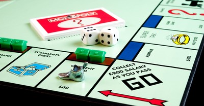 Detailed view of Monopoly board game pieces, dice, and properties.
