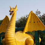 A colorful dragon sculpture situated in a scenic park in Panchkula, India.