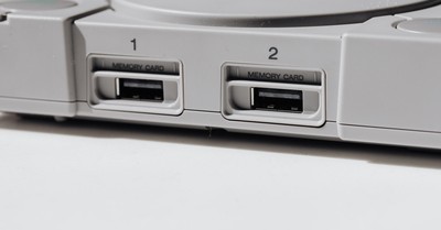 Detailed view of vintage PlayStation console featuring memory slots, capturing nostalgia.
