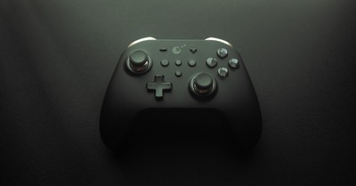 High-quality image of a modern game controller on a smooth black surface, highlighting design and technology.